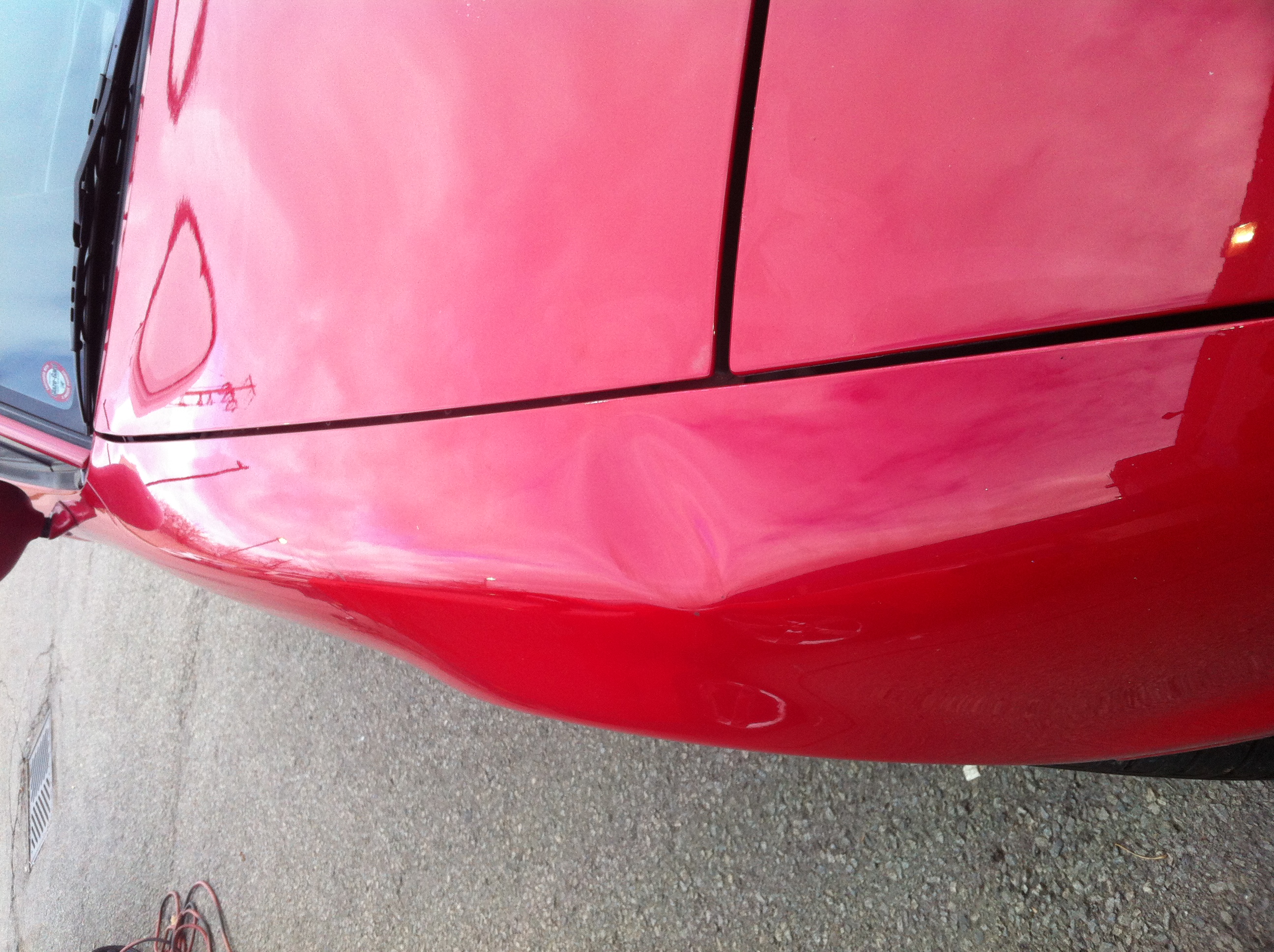 Before rear bodyline dent on red panel