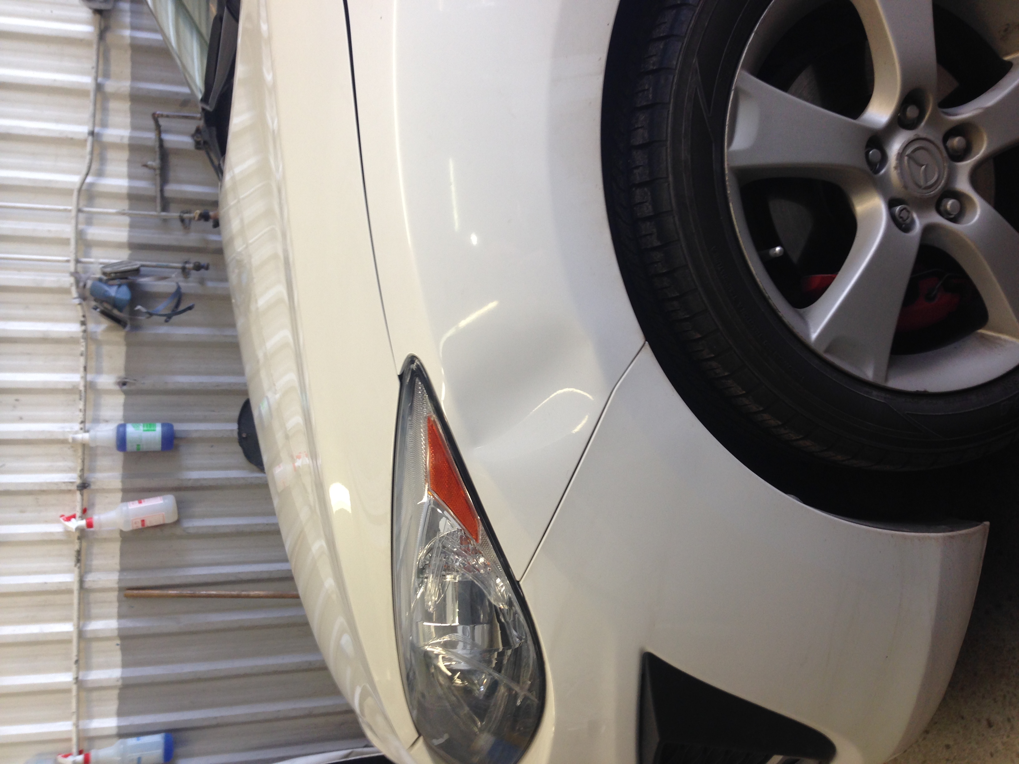 Before subtle front fender dent near wheel arch