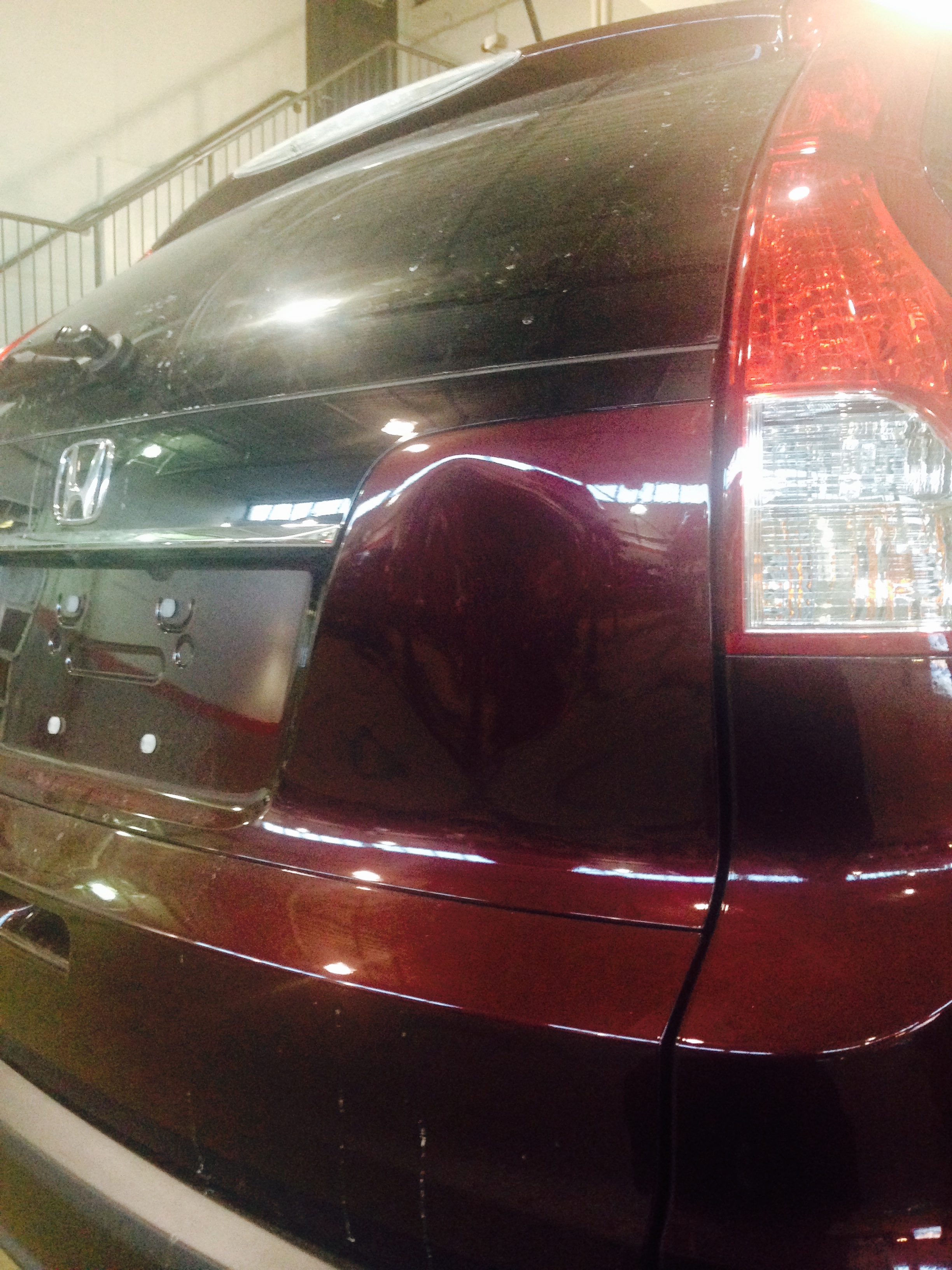 After tailgate dent repair on maroon SUV